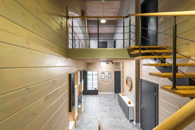 A double-height timber hallway with an open staircase